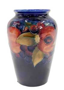 A Moorcroft pottery Pomegranate pattern vase, of shouldered form, on blue ground, 17cm high.