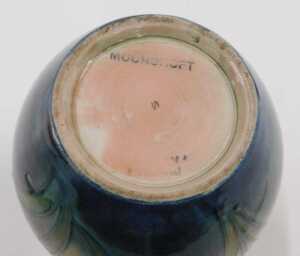 A Moorcroft pottery Freesia pattern vase, of bulbous form with cylindrical stem, on a green... - 2