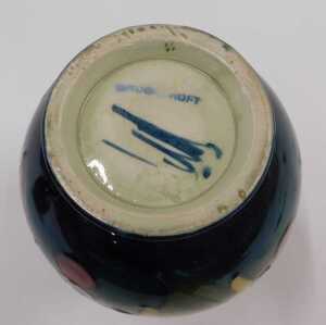 A Moorcroft pottery Leaf and Berry pattern vase, of shouldered form on circular foot, on green... - 2