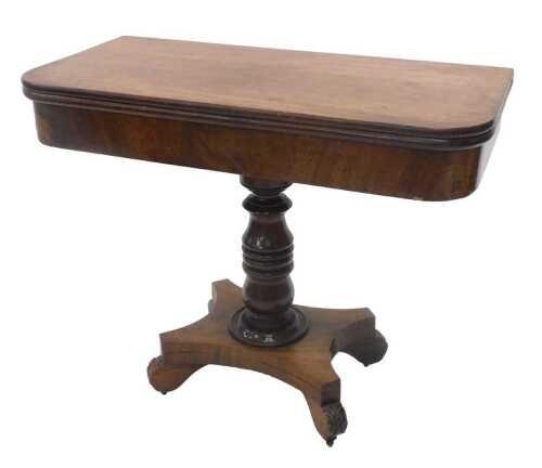 A 19thC mahogany fold over tea table, the D end top raised on a turned stem, terminating in an...