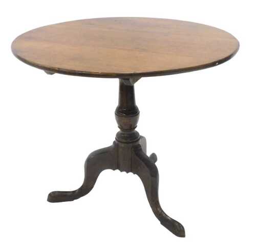 An early 19thC oak tripod table, the plain circular top on a tapering stem with urn section,...