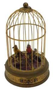A 20thC Continental bird cage automaton, with two birds, partially feathered on a metal floral...