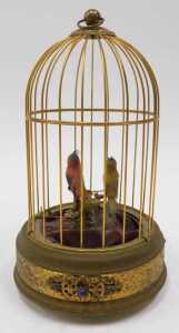 A 20thC Continental bird cage automaton, with two birds, partially feathered on a metal floral... - 2