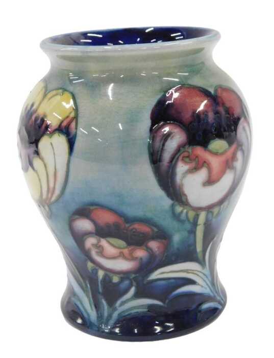 A Moorcroft pottery Multicoloured Poppy pattern vase, of bellied circular form, on green ground,...