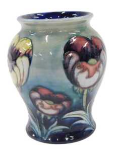 A Moorcroft pottery Multicoloured Poppy pattern vase, of bellied circular form, on green ground,...