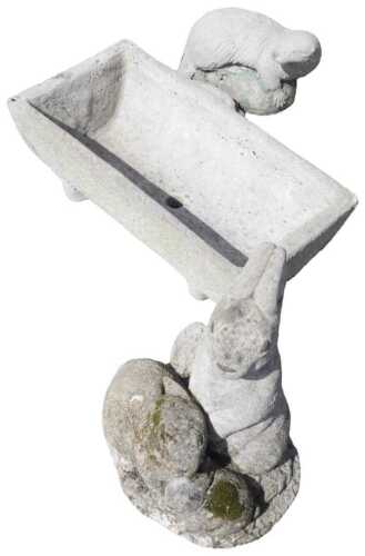 A rectangular stone trough, with central drainer, 61cm wide, and two reconstituted stone garden...