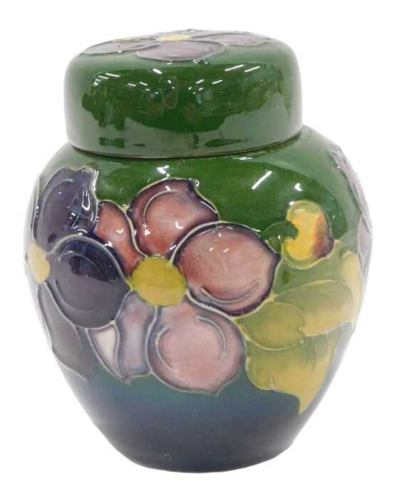 A Moorcroft pottery Clematis pattern miniature ginger jar and cover, on green ground, 12cm high.