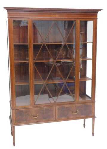 An Edwardian mahogany and boxwood strung display cabinet, the fixed cornice with a dentil motif,...