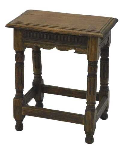 A 20thC Charles I style oak stool, with rectangular pegged top, raised on turned columns, joined...