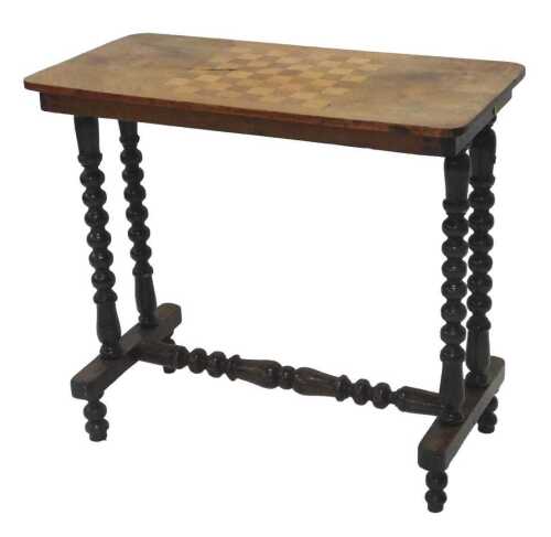 A Victorian walnut and part inlaid games table, of oblong form, with chequer board top, on...