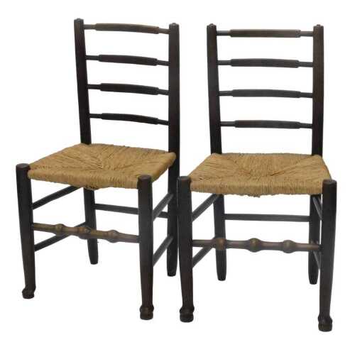 A pair of elm ladderback chairs, with rope seats, on turned front legs joined by a horizontal...