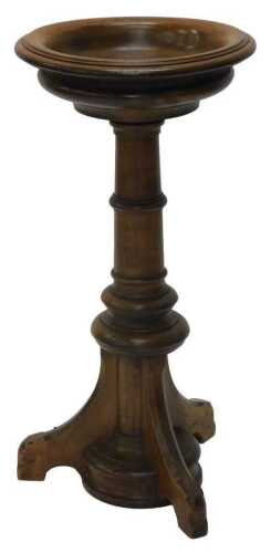 An early 20thC oak font jardiniere stand, by Wylie and Lockhead, Glasgow, the shallow circular...