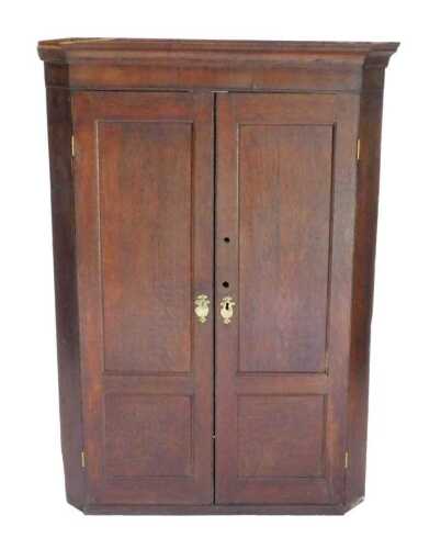 An 18thC oak hanging corner cupboard, with panelled front revealing a fitted interior, 117cm...