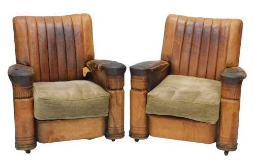 A pair of mid-20thC Art Deco tan leather armchairs, with fan shaped backs, shaped arms, and...