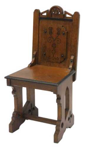 A late 19thC oak aesthetic style hall chair, with a pierced angular and arched cresting rail,...