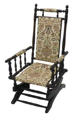A 19thC turned American style rocking chair, with overstuffed cresting rail, back, arms and seat,...