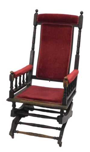 An early 20thC walnut American style rocking chair, with overstuffed cresting rail, back, arms...