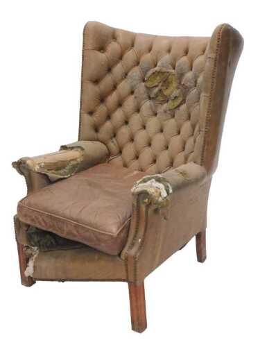 An 18thC style brown leather Chesterfield wingback armchair, with shaped arms, removable seat,...