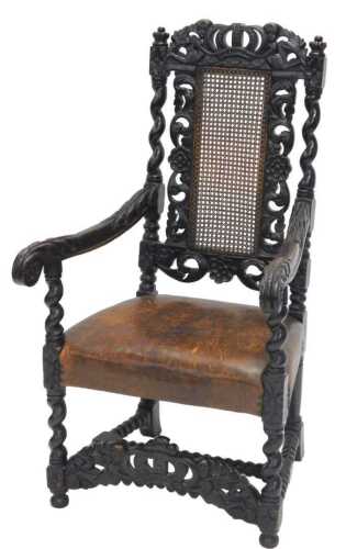 A late 19thC oak Carolean style carver chair, with a carved cherub scroll and floral outline,...