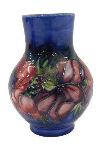 A Moorcroft pottery Anemone pattern vase, of bulbous form, with compressed stem on circular foot,...