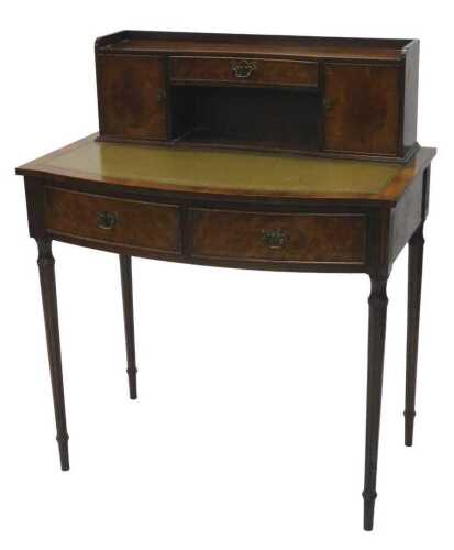 A Victorian style mahogany and walnut writing desk, the three part galleried top raised above an...