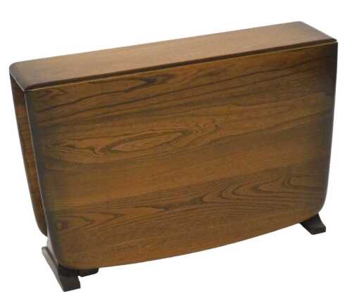 A late 20thC Ercol drop leaf Sutherland table, when closed 47cm high, 64cm wide, 18cm deep.