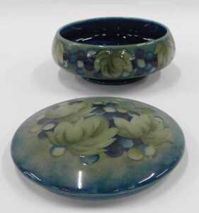 A Moorcroft pottery Leaf and Berry pattern jar and cover, of compressed circular form, on green... - 2