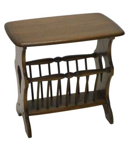 A late 20thC Ercol newspaper rack, the oblong top raised on inverted stiles, with pierced sides,...