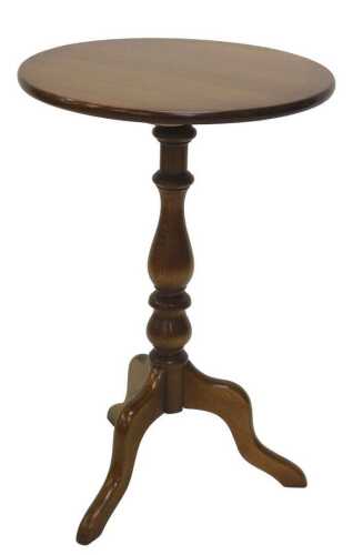 A late 20thC Ercol tripod table, with plain circular top, on baluster stem terminating in...