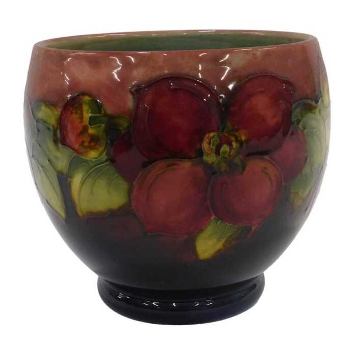 A Moorcroft pottery flambe Clematis pattern vase, of tapering circular form on circular foot,...