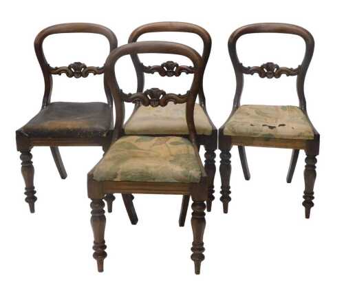 A set of four Victorian mahogany balloon back dining chairs, each with heavily carved scroll...