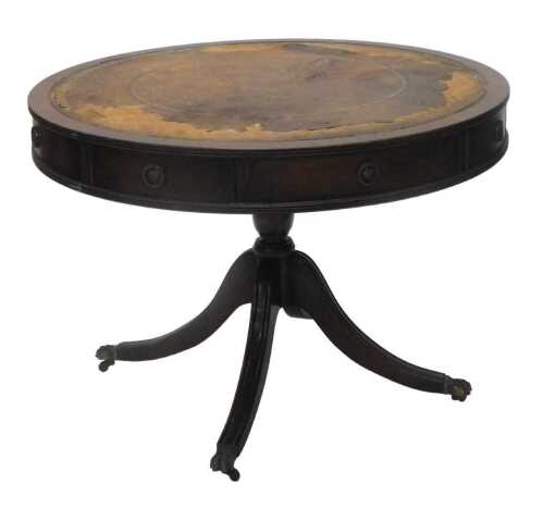 A George III style 20thC mahogany drum table, the circular top with a part gilt stencilled...