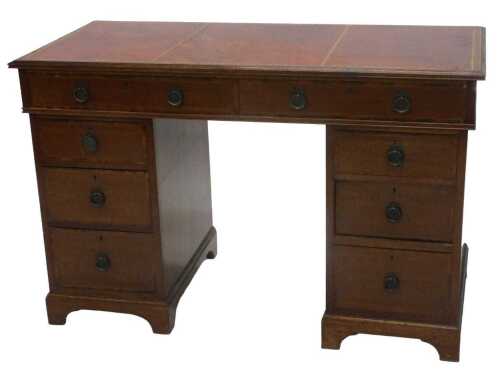 A 20thC twin pedestal writing desk, with one piece part tooled red leather top, raised above two...