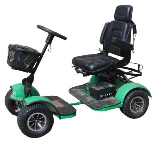 A Hillman electric golf buggy, in green, with front basket, part electrical charger, and space...