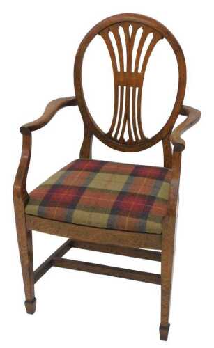 A 19thC oak Hepplewhite style carver chair, with an inverted pierced backsplat above shaped arms,...