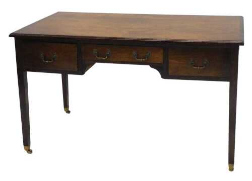An Edwardian mahogany desk, the rectangular top raised above three frieze drawers, on square...