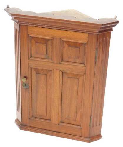 A 20thC Georgian style walnut hanging corner cupboard of small proportion, with panelled door...