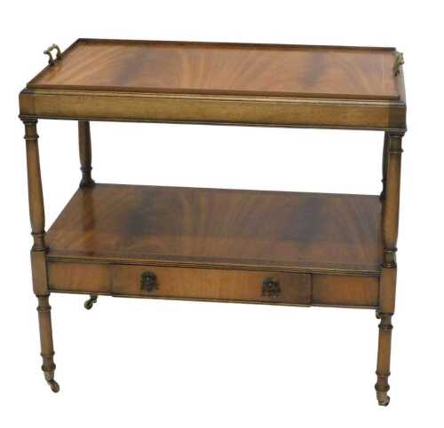 A 20thC flame mahogany finish dinner wagon, the tray top with brass handles and a wide...