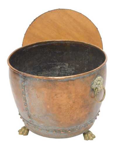 A 19thC copper and brass log bin jardiniere, of tapering circular form, with heavy lion's mask...