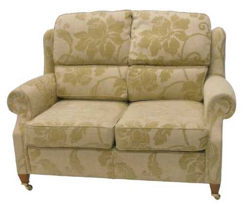 An Edwardian style two seater lounge settee, with removable back and seat cushions, upholstered...