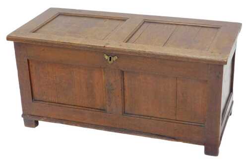 An 18thC oak two panelled coffer, the plain lid revealing a plain interior with candle box...