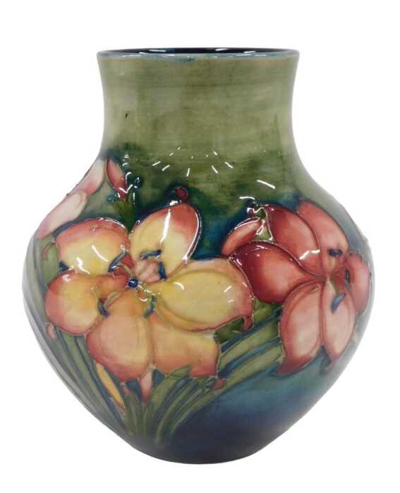 A Moorcroft pottery Freesia pattern vase, of bellied circular form, on green ground, 14cm high.