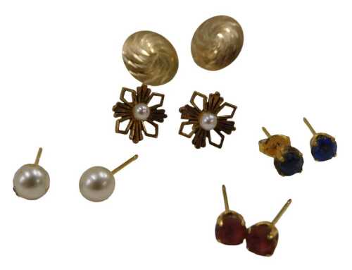 A group of unmarked yellow metal and other earrings, comprising disk studs, a pair of pearl...