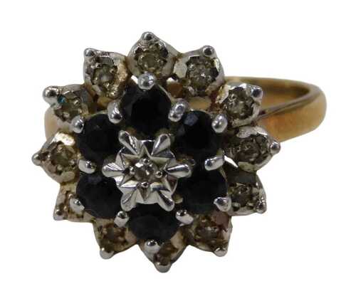 A 9ct gold sapphire and diamond cluster ring, formed as three layers, set in white and yellow...