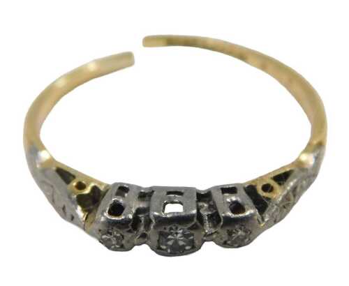 A three stone diamond dress ring, set in platinum, on a yellow metal band, cut, ring size P,...