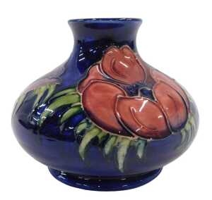 A Moorcroft pottery Anemone pattern squat vase, of bellied circular form on circular foot, on...