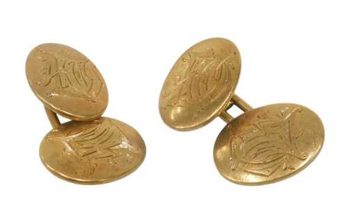 A pair of cufflinks, each with oval chain link, bearing the initials FM, yellow metal, stamped...