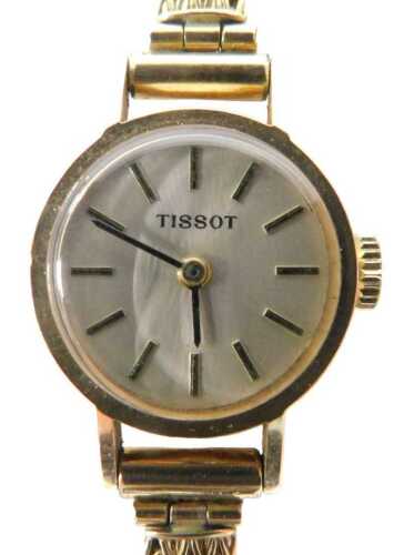 A Tissot 9ct gold lady's wristwatch, with a silvered and baton black handled dial, 1.5cm wide,...