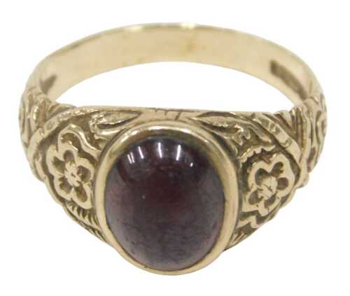 A 9ct gold signet ring, with a cabochon cut garnet in rub over setting, with floral design...