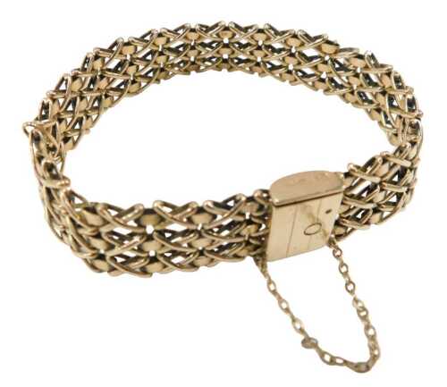 A 9ct gold gate bracelet, of cross and bar three row design, 14cm long, 18.2g.